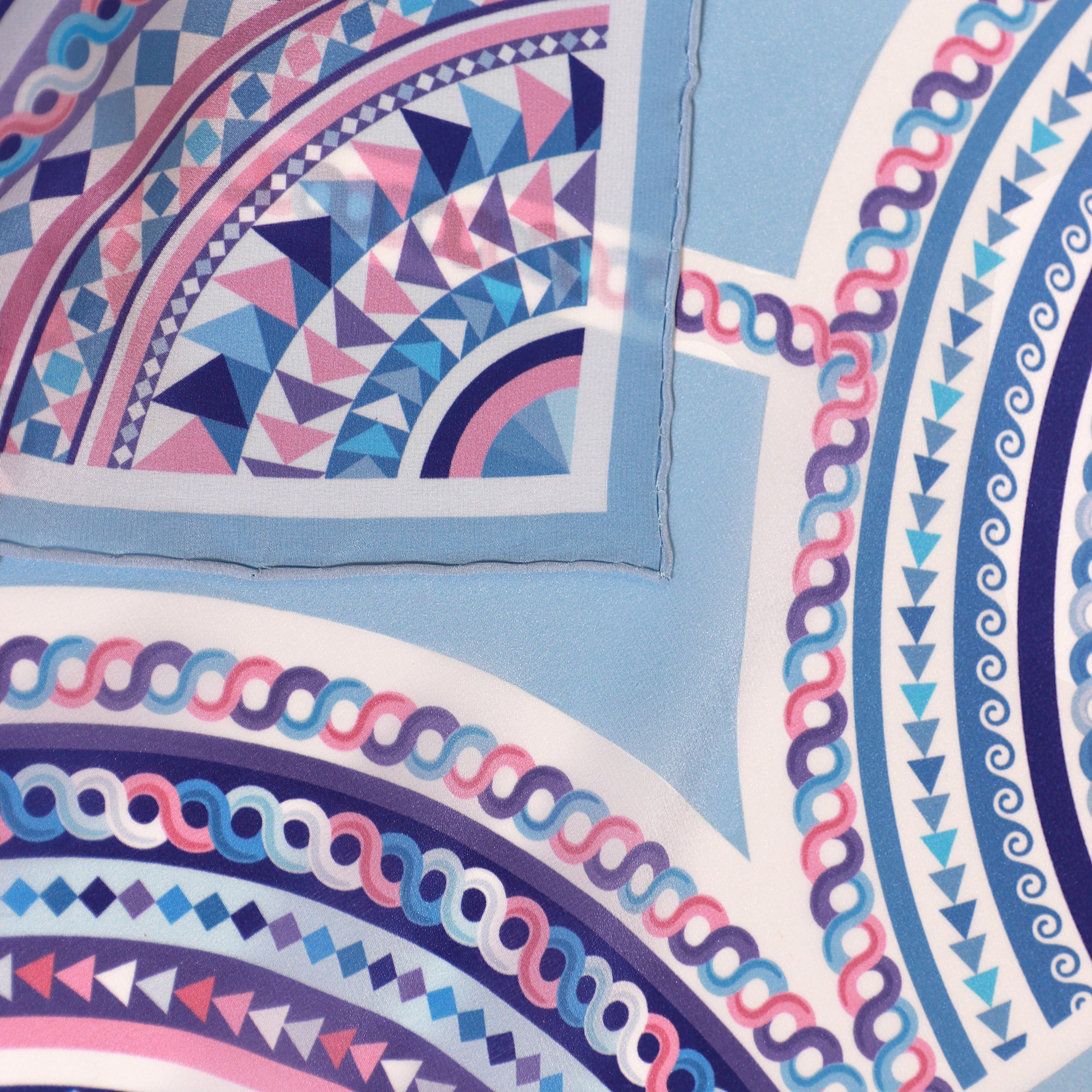 Detail of the Basilica Zaffiro silk scarf showing geometric and architectural motifs and the hand-rolled hem.