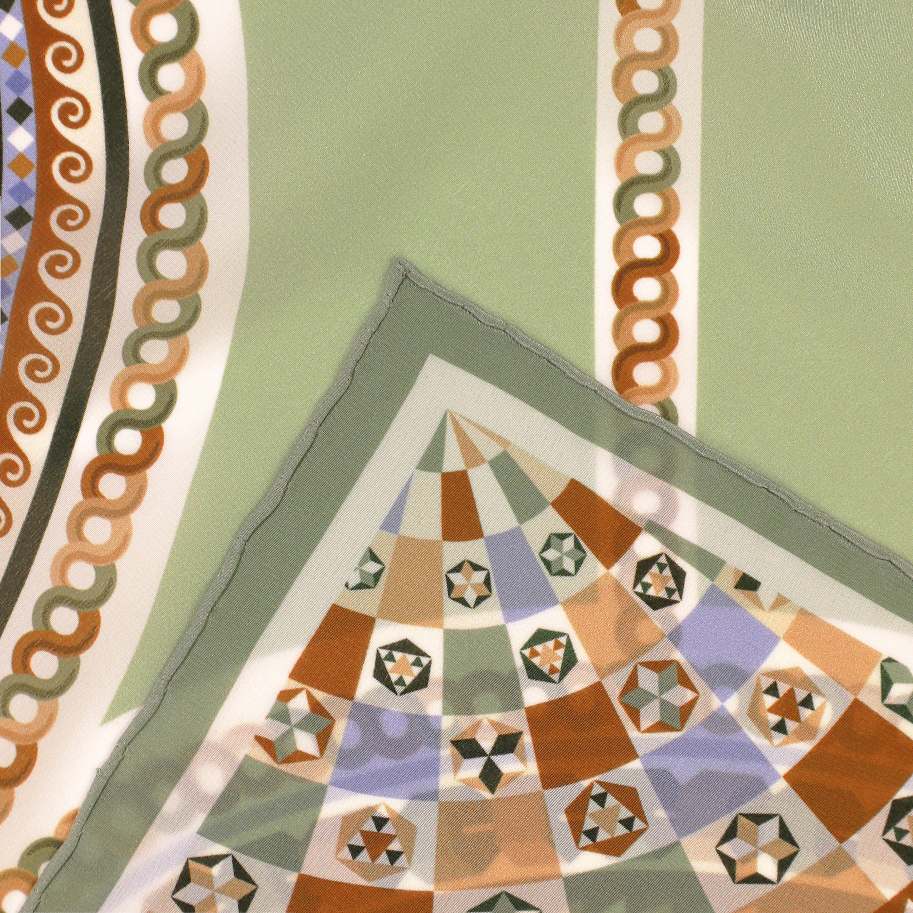 Detail of the Basilica Giada silk scarf showing geometric and architectural motifs and the hand-rolled hem.