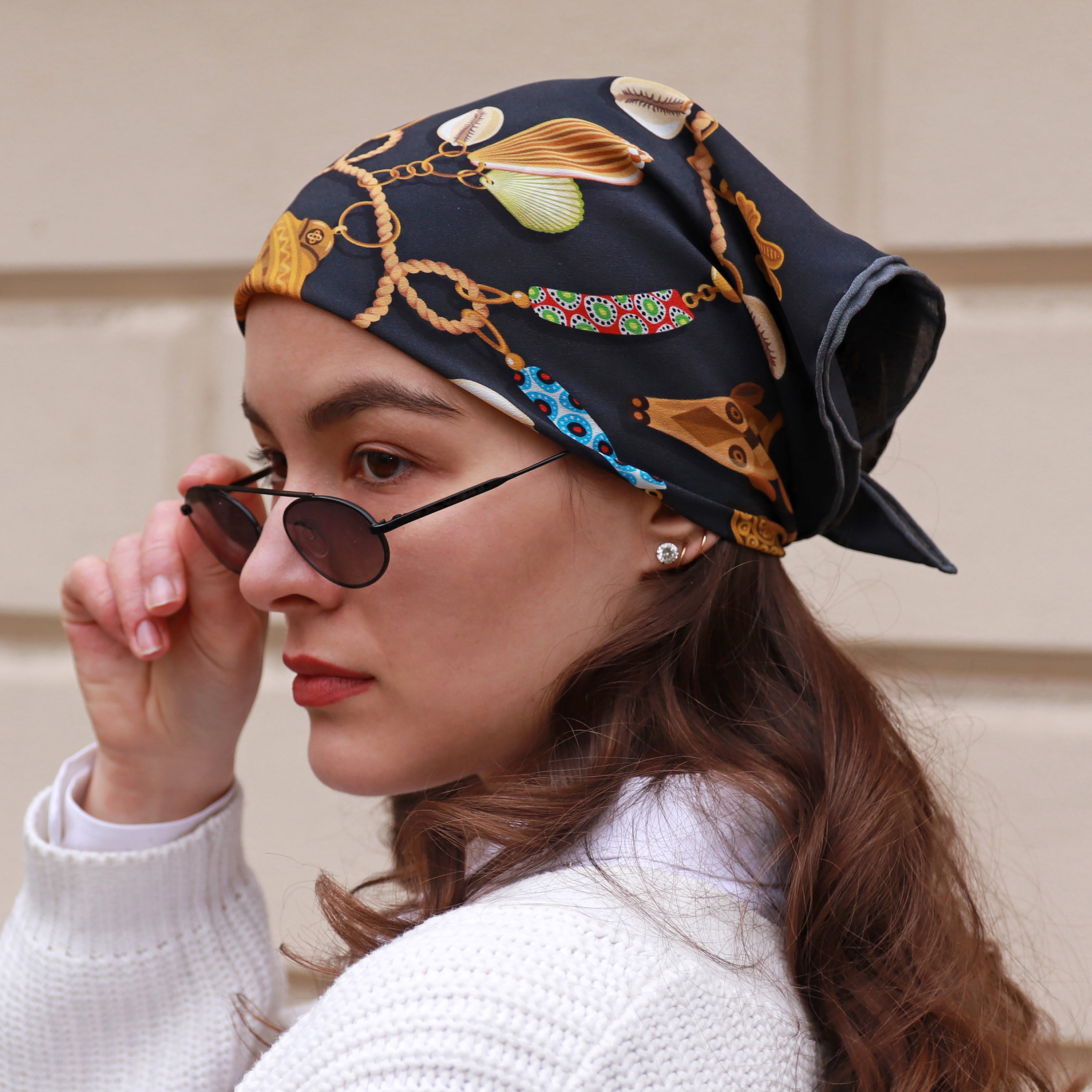 Model wearing the Kauri Chloe silk bandana scarf styled as a headscarf.