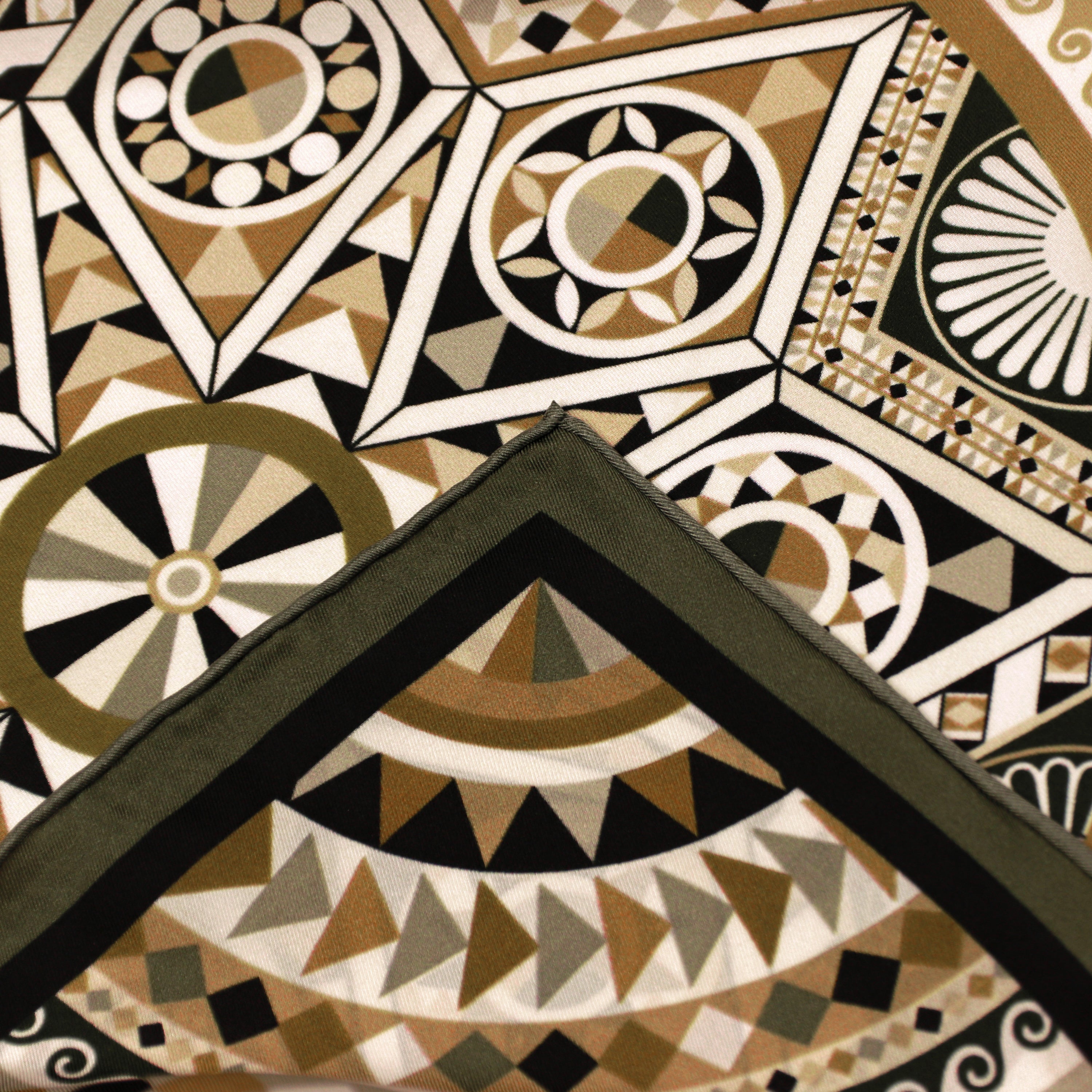 Detail of the Basilica Nero silk scarf showing geometric and architectural motifs and the hand-rolled hem.