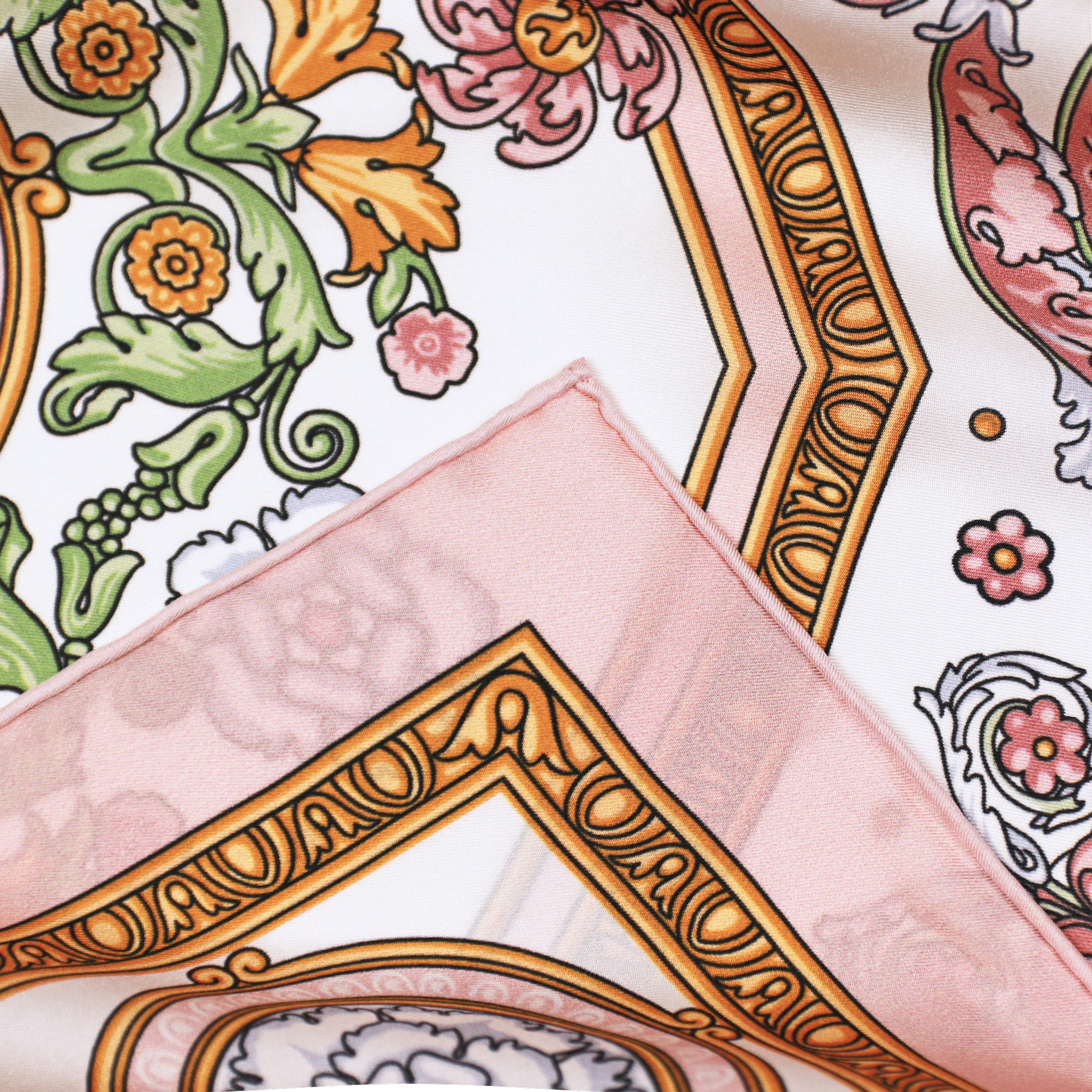 Detail of the Rococo Rosa silk scarf showing floral and rococo motifs and the hand-rolled hem.