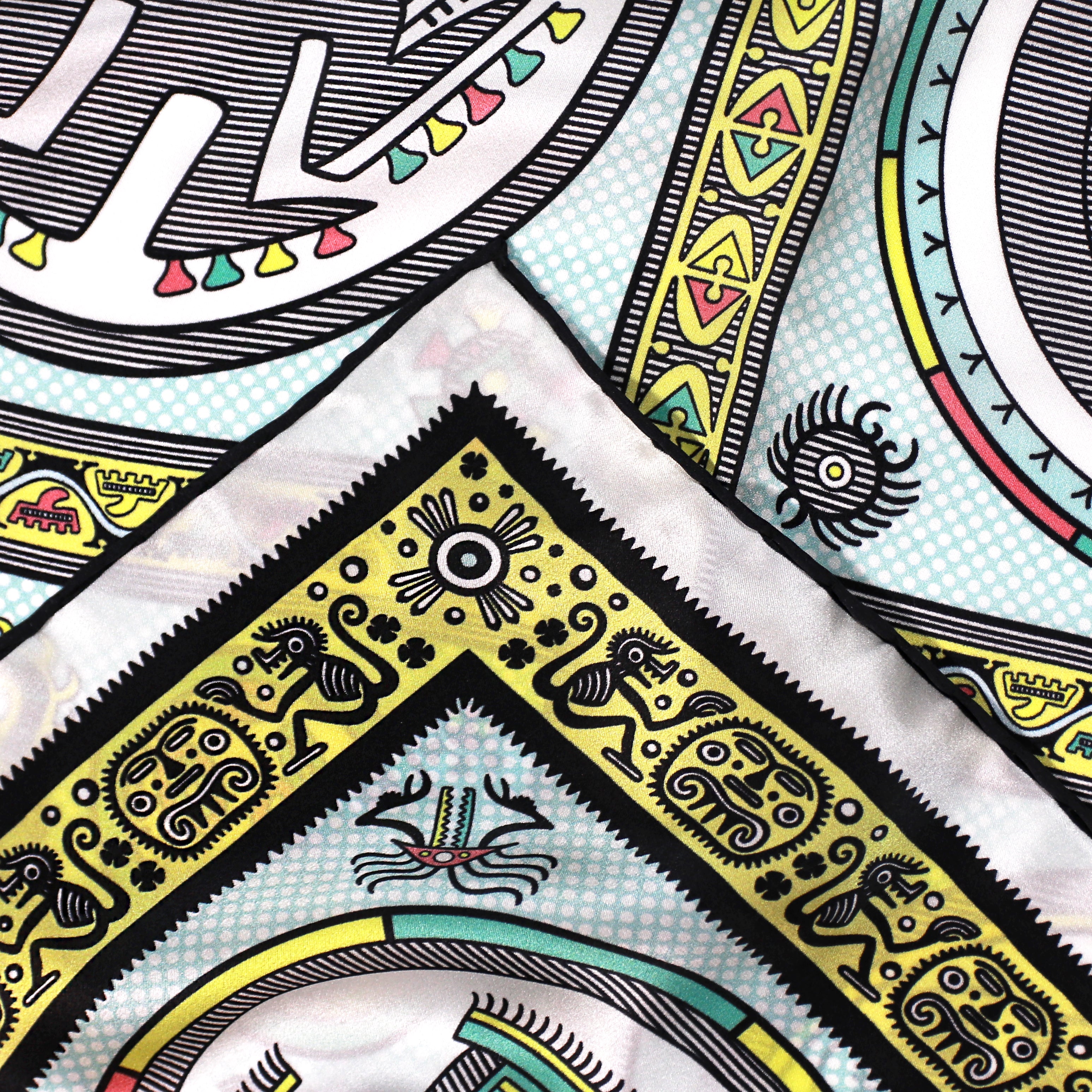 Detail of the Gran Coclé Opal silk scarf showing geometric and ritual-inspired motifs and the hand-rolled hem.